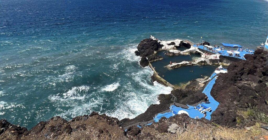 Blue platforms and natural volcanic pools alongside the Atlantic ocean in Madeira.