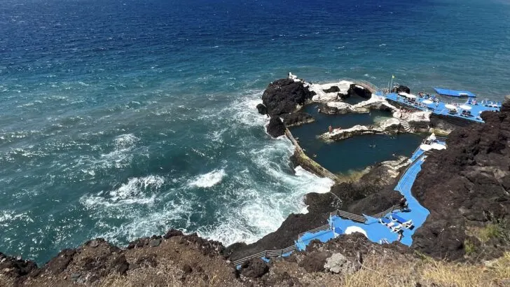 Blue platforms and natural volcanic pools alongside the Atlantic ocean in Madeira.