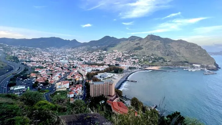 View over the traditional Madeiran town of Machico on the east coast, surrounded by hills.